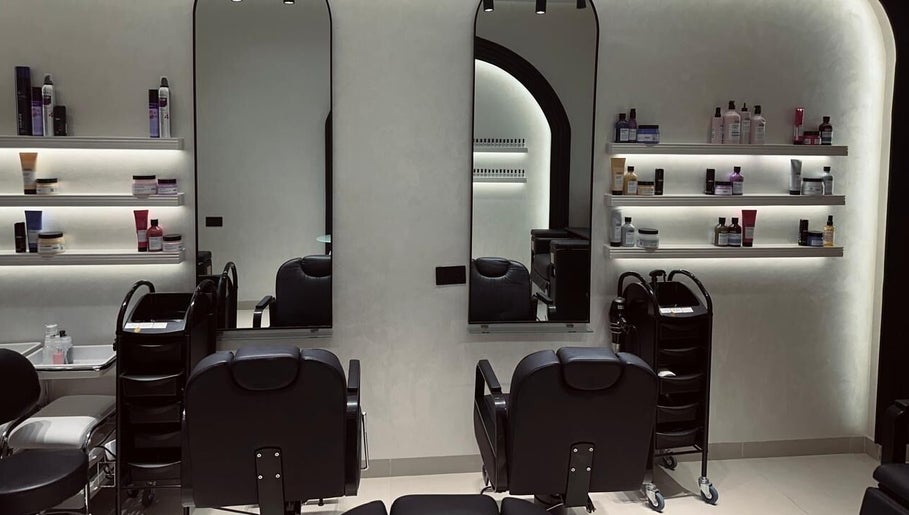 Interior of Velvet Rose Women Salon, Dubai, featuring sleek styling stations and beauty products on shelves.