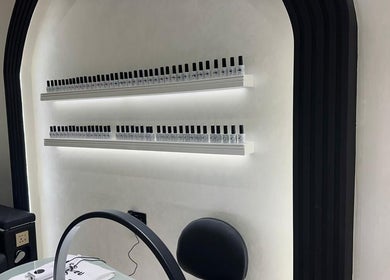 Nail polish display at Velvet Rose Women Salon, Dubai. Sleek shelves with modern decor and elegant chair setup.