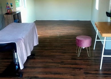 Relaxing massage room at Recovery Massage Therapy, Omagh, Northern Ireland, GB with a massage table and stool.