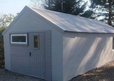 Tranquil exterior of Recovery Massage Therapy in Omagh, Northern Ireland, GB, surrounded by serene trees.