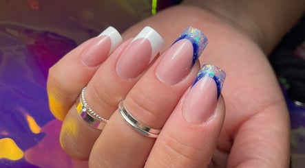 Elegant nail art with blue glitter tips at Sylwia Nails & Beauty, Cork, County Cork, IE.