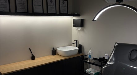 Modern treatment room at Kaesthetics Clinic, Dublin, County Dublin, IE featuring sleek sink and chair.