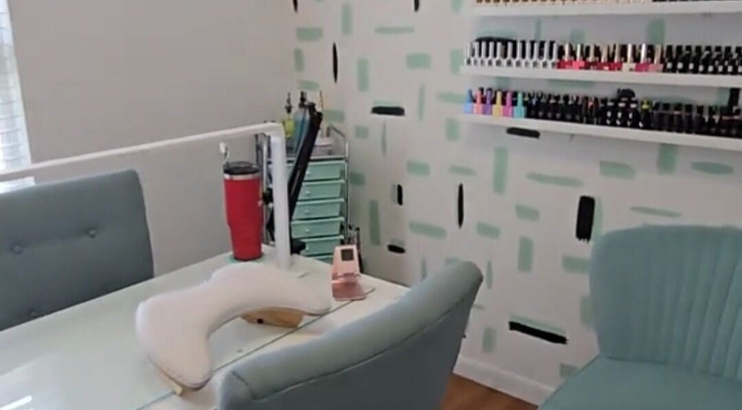 Modern nail station at Te Crees Mucho Nail Studio, Dallas, Texas, US, with chic chairs and polish display.