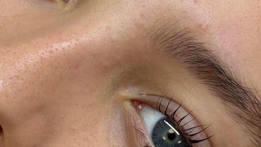 Close-up of a well-groomed eyebrow and blue eye at BeautifulByDD, Bearsden, Scotland, GB.