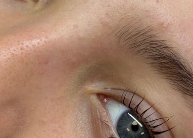 Close-up of a well-groomed eyebrow and blue eye at BeautifulByDD, Bearsden, Scotland, GB.