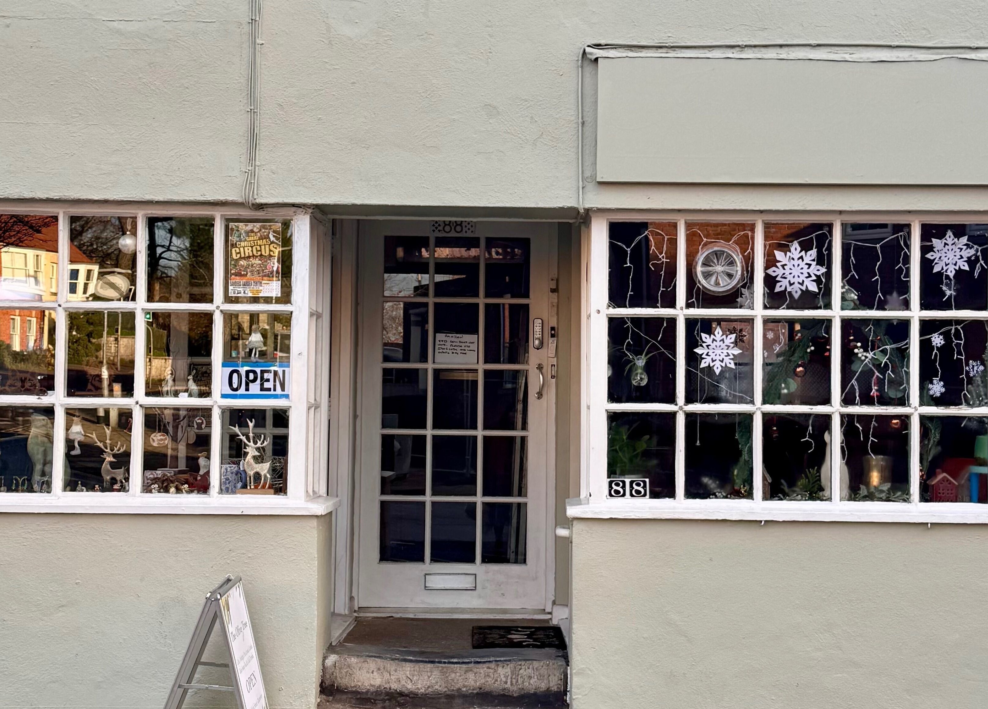 Front view of Avalon Hair Rituals in Glastonbury, England, GB, featuring festive window decorations.