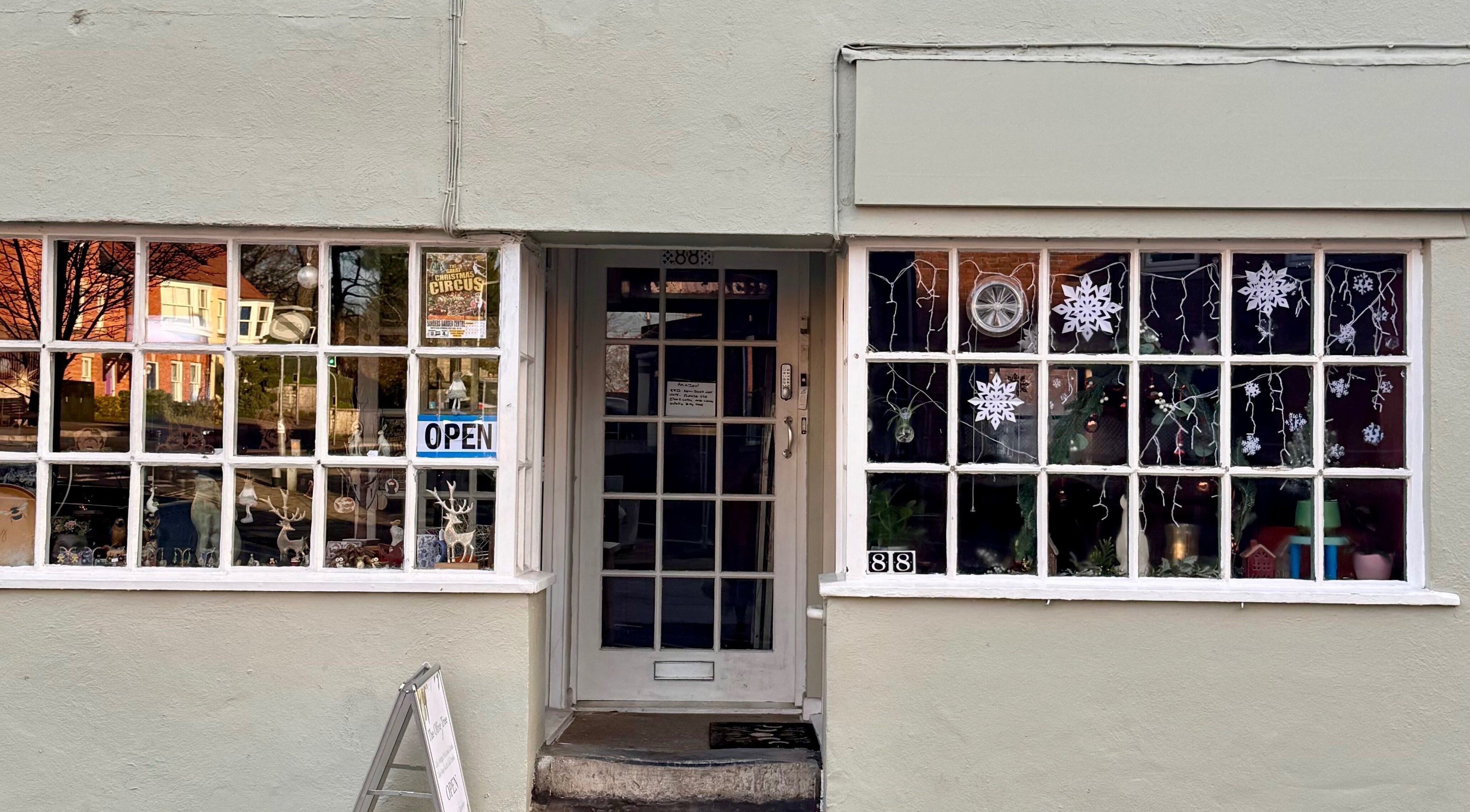 Front view of Avalon Hair Rituals in Glastonbury, England, GB, featuring festive window decorations.