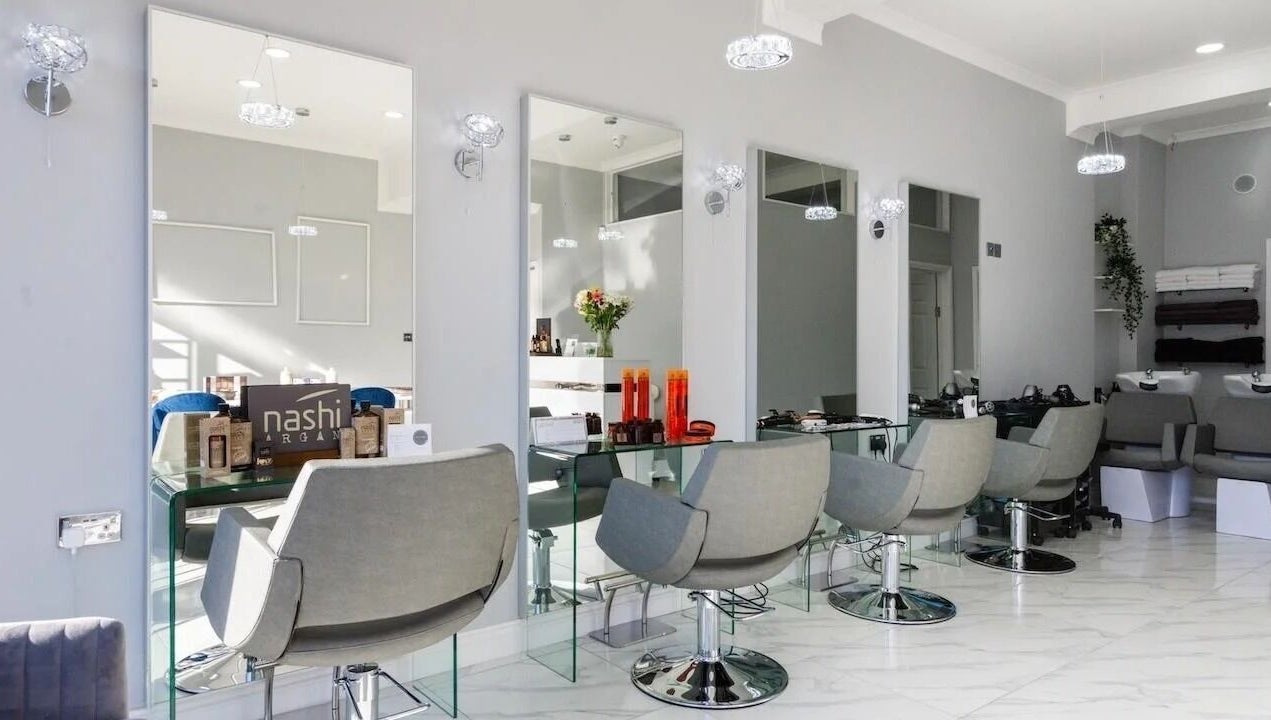 Modern salon interior at Studio N, West Wickham, England, GB with stylish chairs and mirrors.