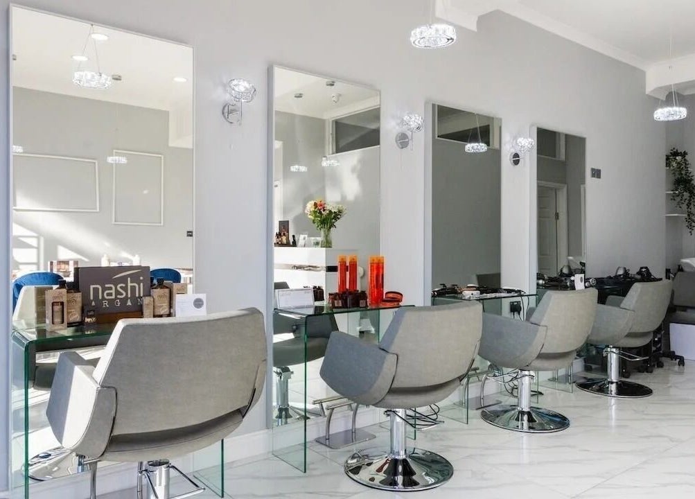 Modern salon interior at Studio N, West Wickham, England, GB with stylish chairs and mirrors.