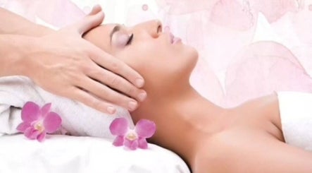 Relaxing head massage at Mary Vanity, East Kilbride, Scotland, GB with orchids in a tranquil setting.