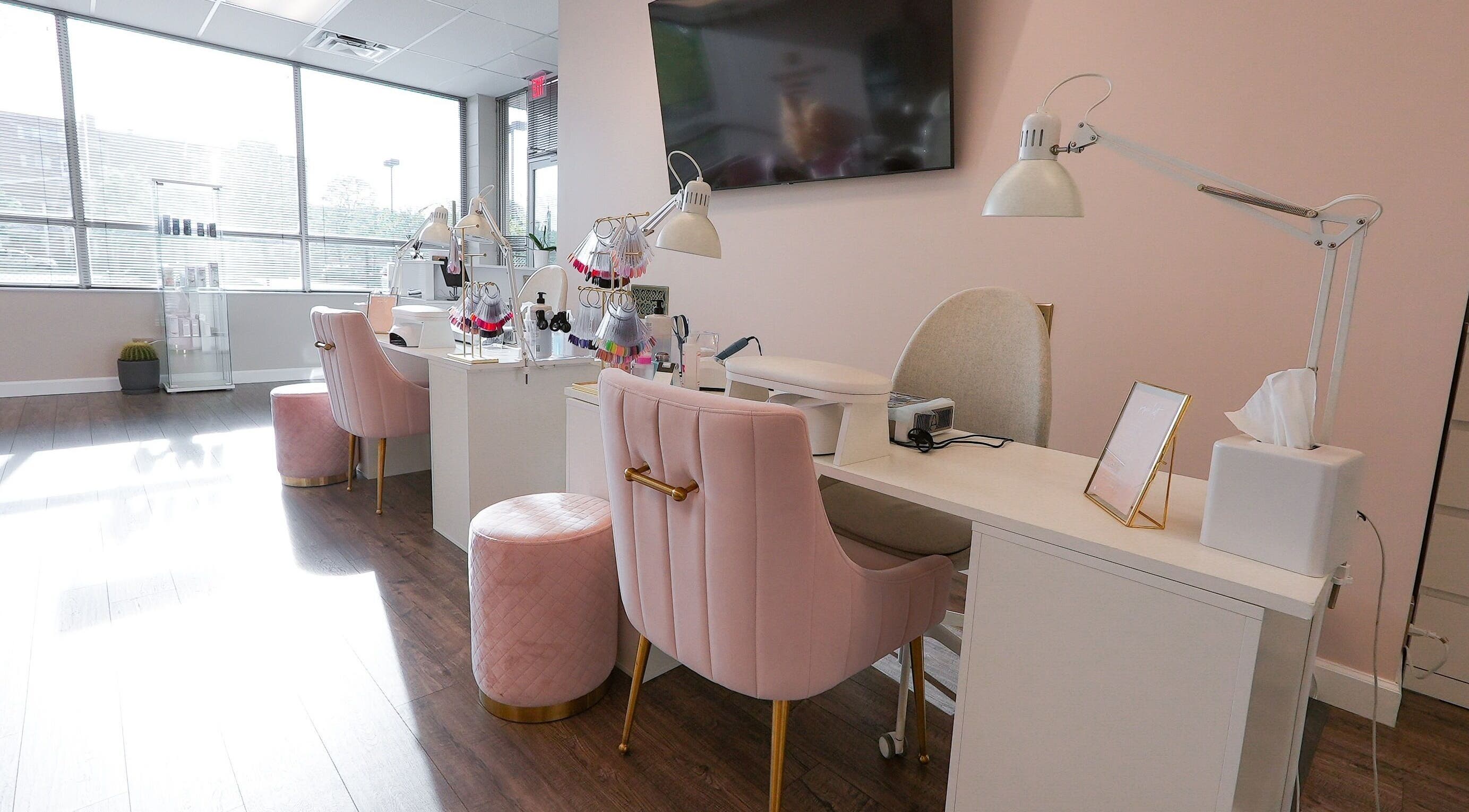 Elegant nail salon setup in Kvadrat Room, Des Plaines, Illinois, US with pink chairs and modern decor.