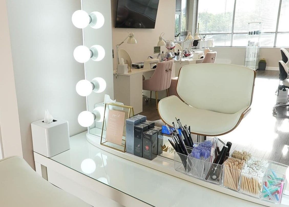 Elegant makeup station at Kvadrat Room, Des Plaines, Illinois, US, with bright lights and beauty tools.