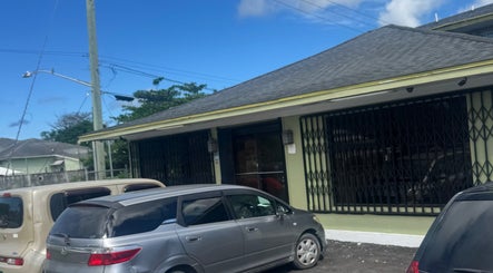 Exterior of Facial Expressions Artistry in Nassau, New Providence, BS, featuring parking area.
