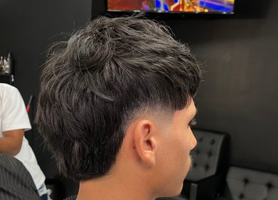 Man receiving a stylish haircut at Ritual - Classic Barbershop, Logan, Utah, US.