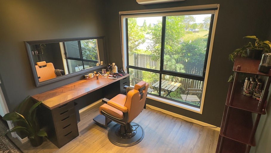 Elegant barber chair by window at Caleb Sweeney Barber in Nirimba, Queensland, AU with grooming tools visible.