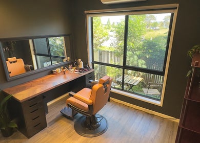 Elegant barber chair by window at Caleb Sweeney Barber in Nirimba, Queensland, AU with grooming tools visible.