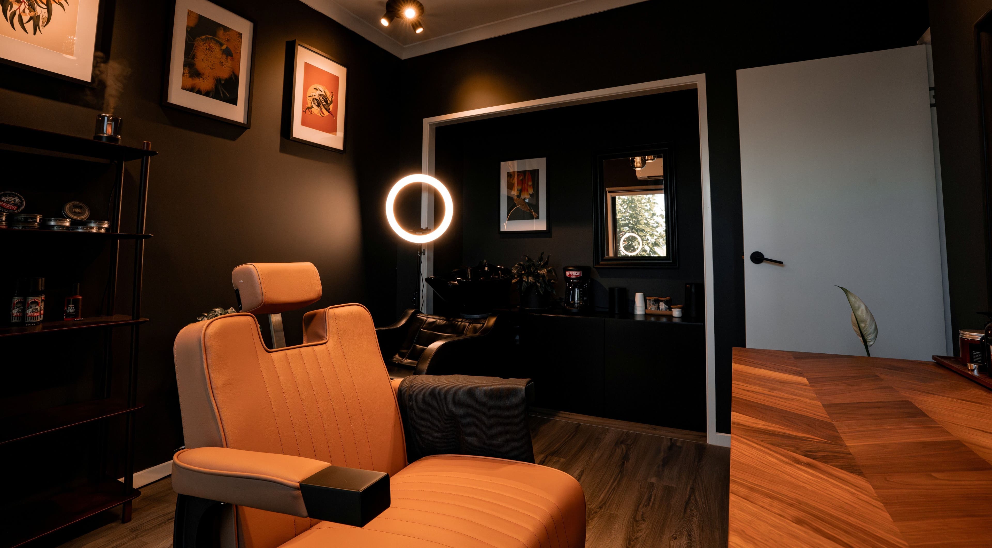 Cozy barber chair in Caleb Sweeney Barber's stylish space, Nirimba, Queensland, AU. Modern decor and warm lighting.