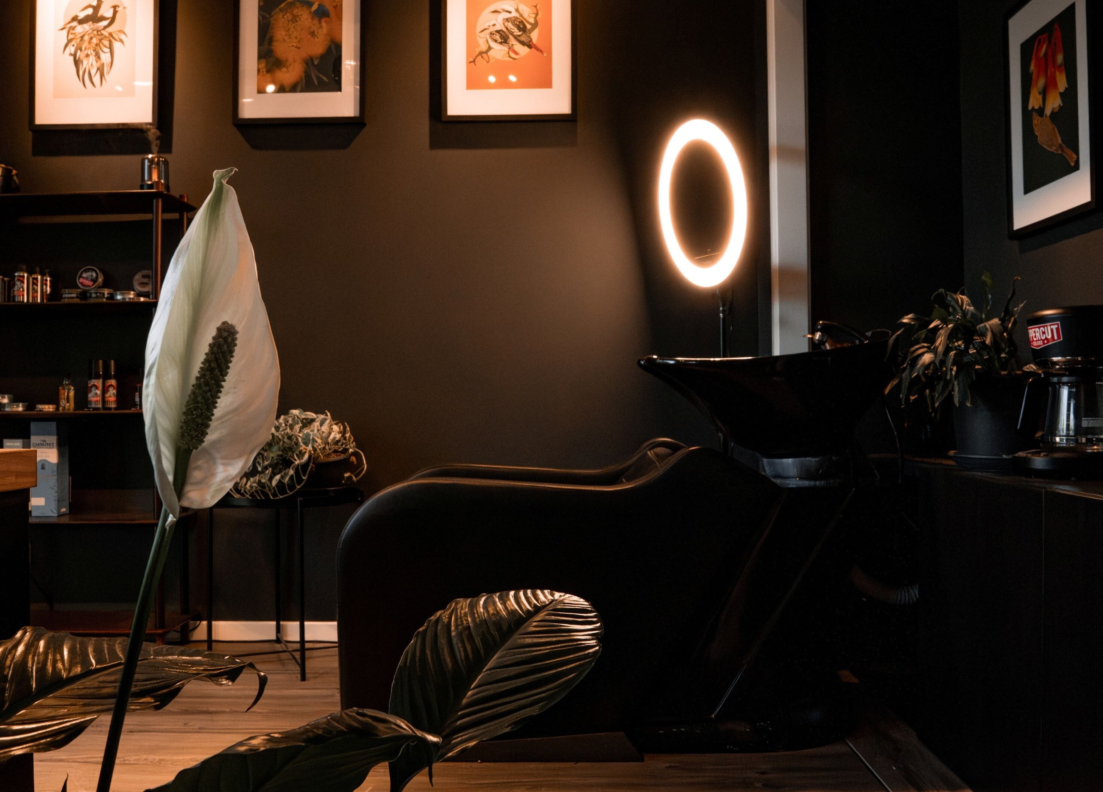 Stylish interior of Caleb Sweeney Barber in Nirimba, Queensland, AU, featuring modern decor and warm lighting.