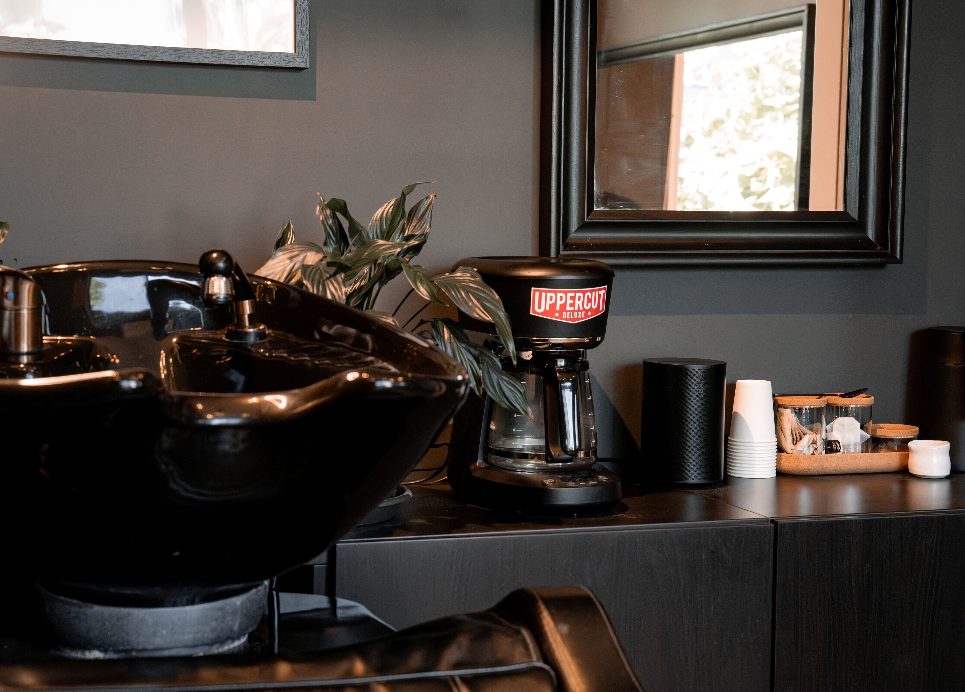 Stylish wash station at Caleb Sweeney Barber in Nirimba, Queensland, AU with modern decor and grooming tools.