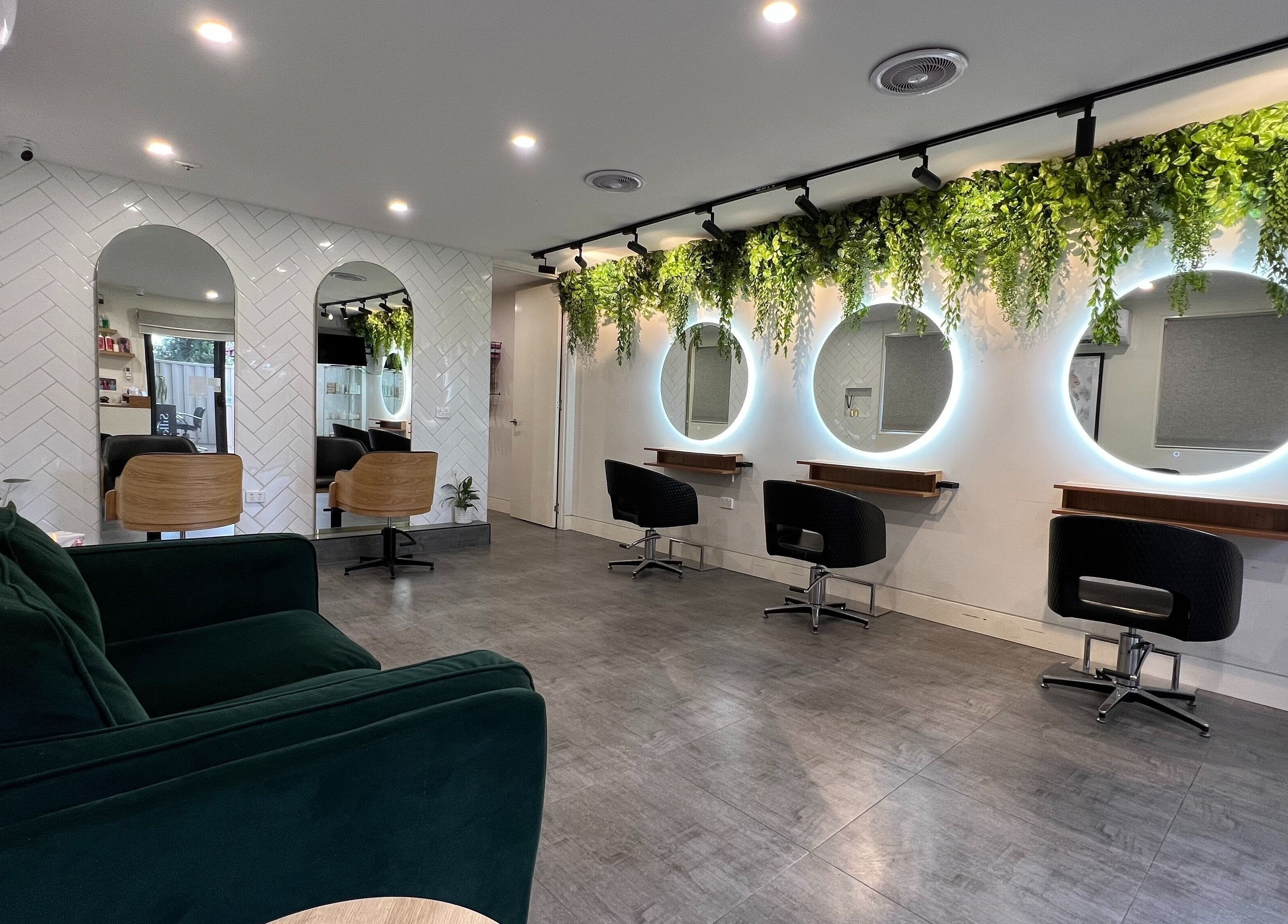 Elegantly styled space at Hairjaz Studio, Melbourne, Victoria, AU with lush greenery and modern mirrors.