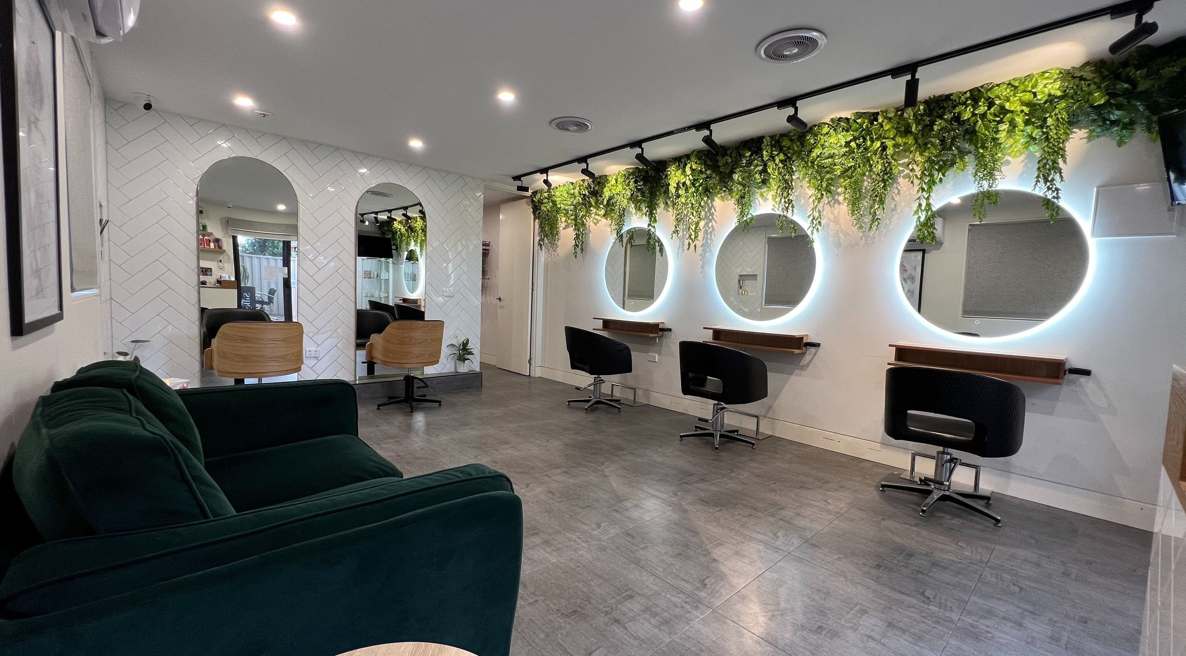 Elegantly styled space at Hairjaz Studio, Melbourne, Victoria, AU with lush greenery and modern mirrors.