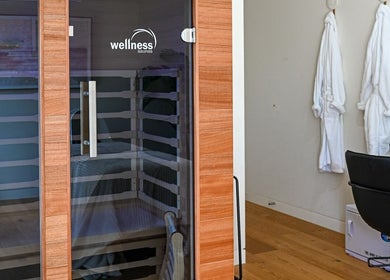 Relaxing sauna room at The Dtox Room in Melbourne, Victoria, AU with cozy robes and modern facilities.
