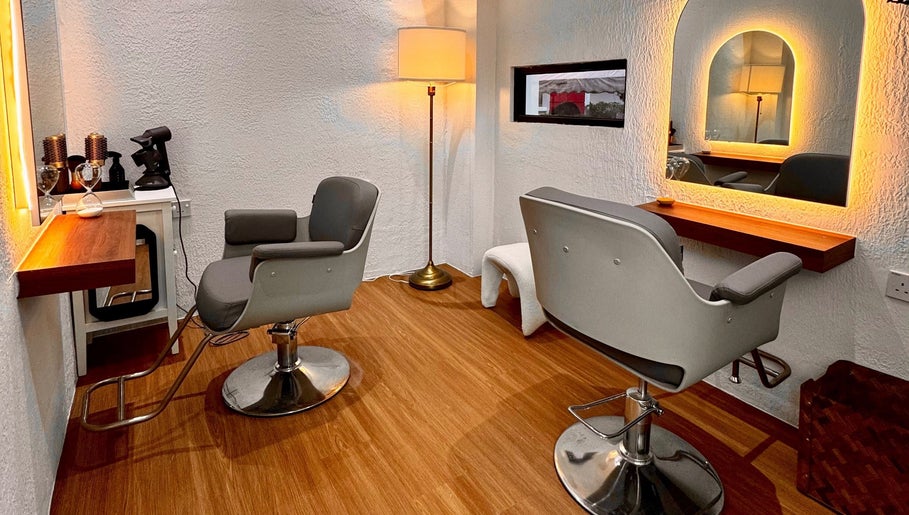 Elegant salon space at Hairkunst Hijabis Luxe, Bandar Baru Bangi, Selangor, MY, featuring modern chairs and warm lighting.