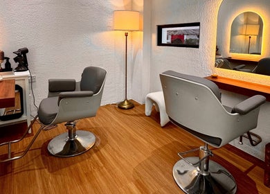 Elegant salon space at Hairkunst Hijabis Luxe, Bandar Baru Bangi, Selangor, MY, featuring modern chairs and warm lighting.