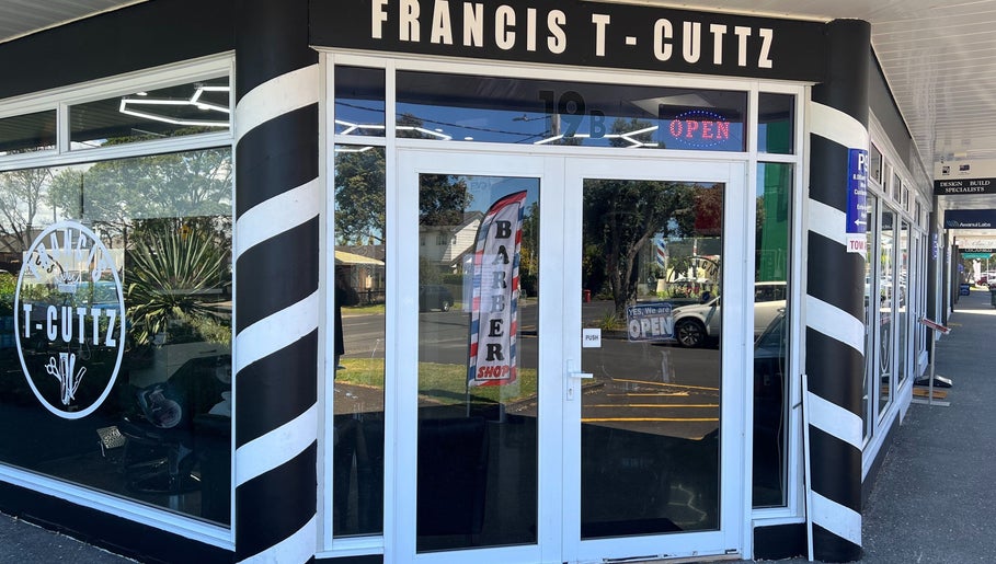 Entrance of Francis T Cuttz, a barber shop in Auckland, Auckland, NZ, with iconic barber pole design.