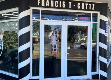 Entrance of Francis T Cuttz, a barber shop in Auckland, Auckland, NZ, with iconic barber pole design.