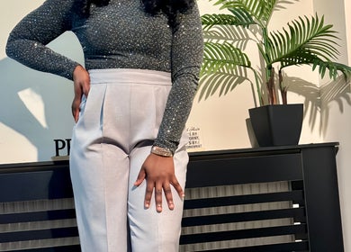 Stylish outfit at Leeihmarh, Plymouth, England, GB featuring a sparkling top and tailored pants near modern decor.