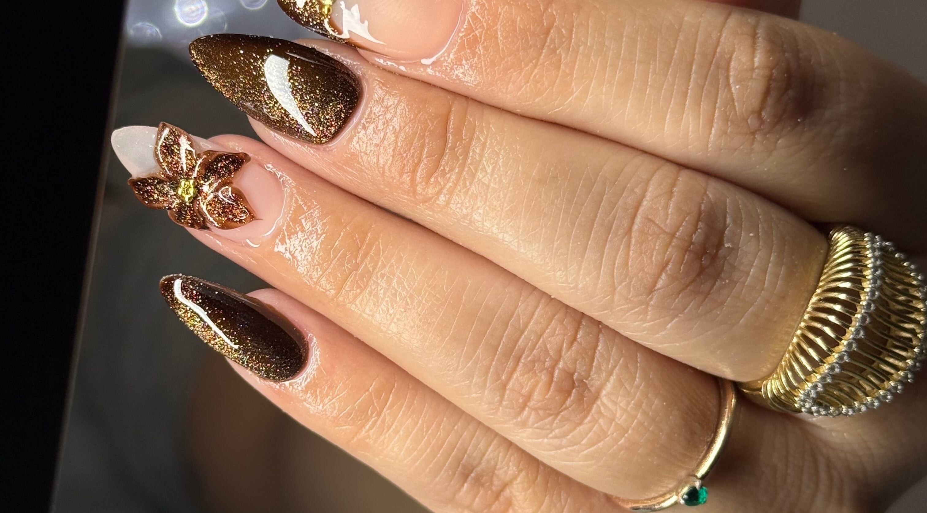 Elegant glittering nails with gold design at Nailology Las Vegas, Las Vegas, Nevada, US.
