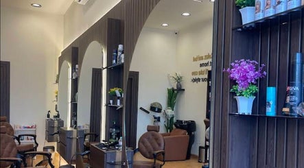 Interior view of Razor Origin Barbershop in Buqayq, Eastern Province, SA, featuring stylish chairs and decor.