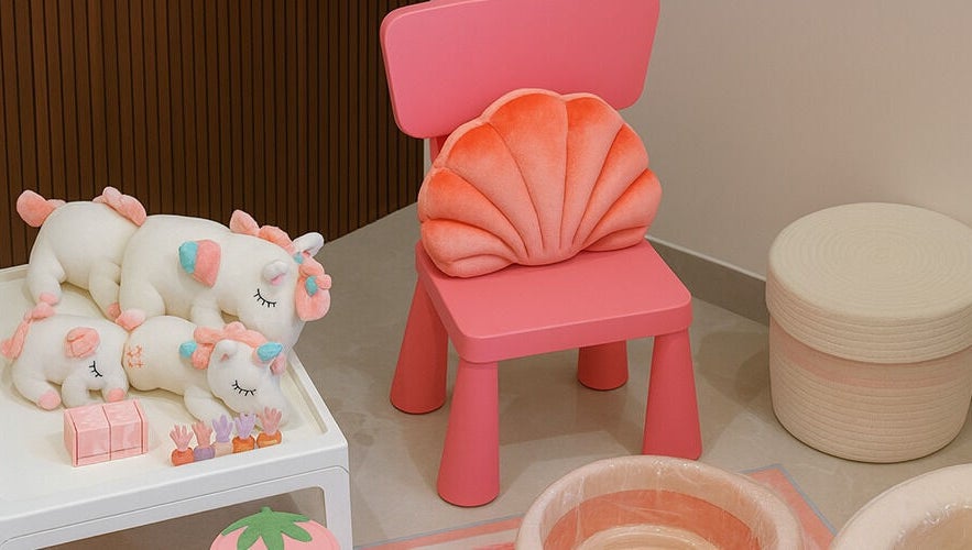 A cozy pink chair with plush unicorns at زوز للعناية النسائي - Zooz care, Riyadh, Riyadh Province, SA.