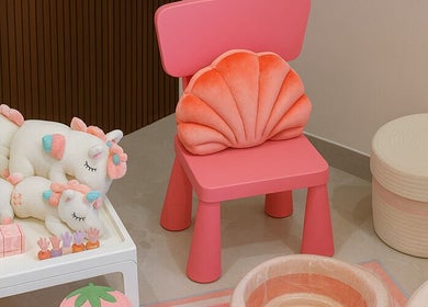 A cozy pink chair with plush unicorns at زوز للعناية النسائي - Zooz care, Riyadh, Riyadh Province, SA.