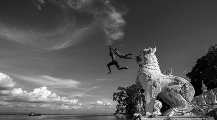 Two kids leap into a river from a lion statue near B M Co, Tanauan City, Calabarzon, PH.