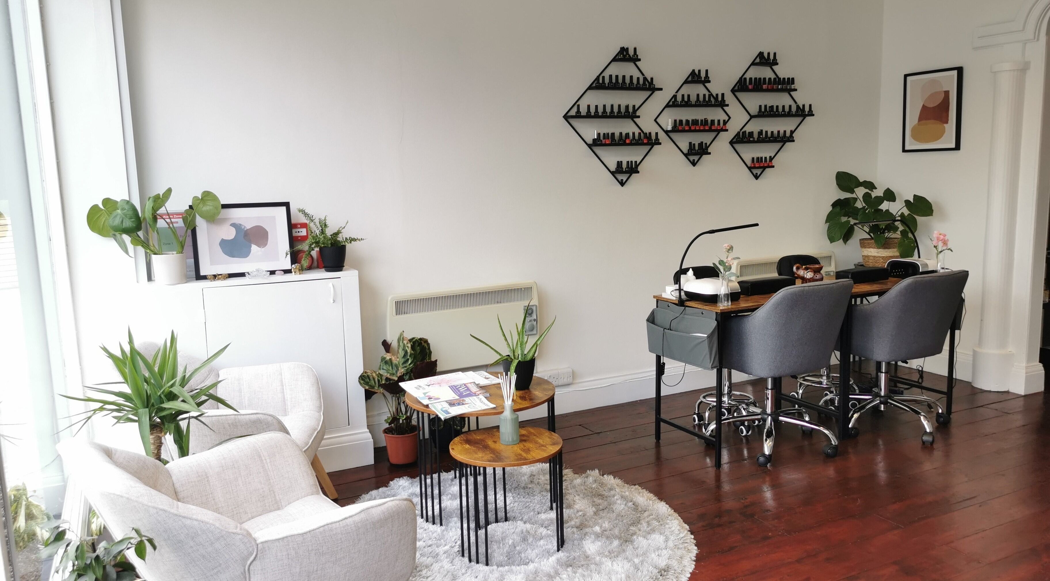 Cozy manicure area at Aura Therapies, Bristol, England, GB, featuring comfortable chairs and stylish decor.