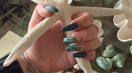 Elegant teal nails with starfish at Enchanted Tips, Kempton Park, Gauteng, ZA, showcasing ocean-inspired designs.