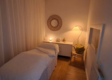Cozy massage room lit softly with ambient lamp at Calma Studio, Melbourne, Victoria, AU.
