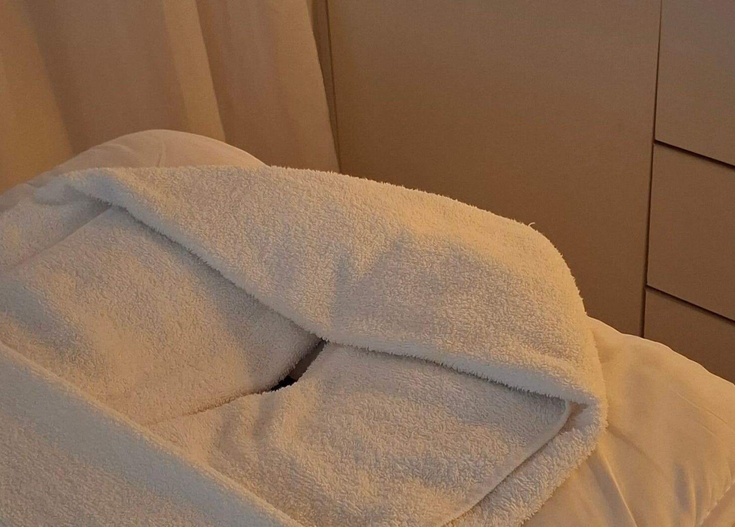 Calma Studio treatment bed with white linens in Melbourne, Victoria, AU, offering a tranquil ambiance.