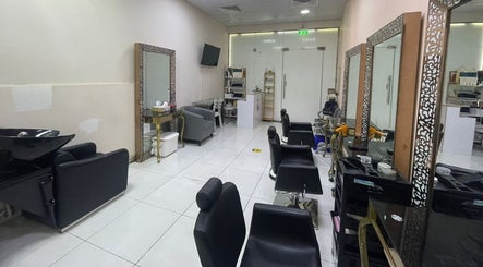 Spacious interior of Sparkles N Charms Womens Beauty Salon in Dubai, AE showcasing modern chairs and mirrors.