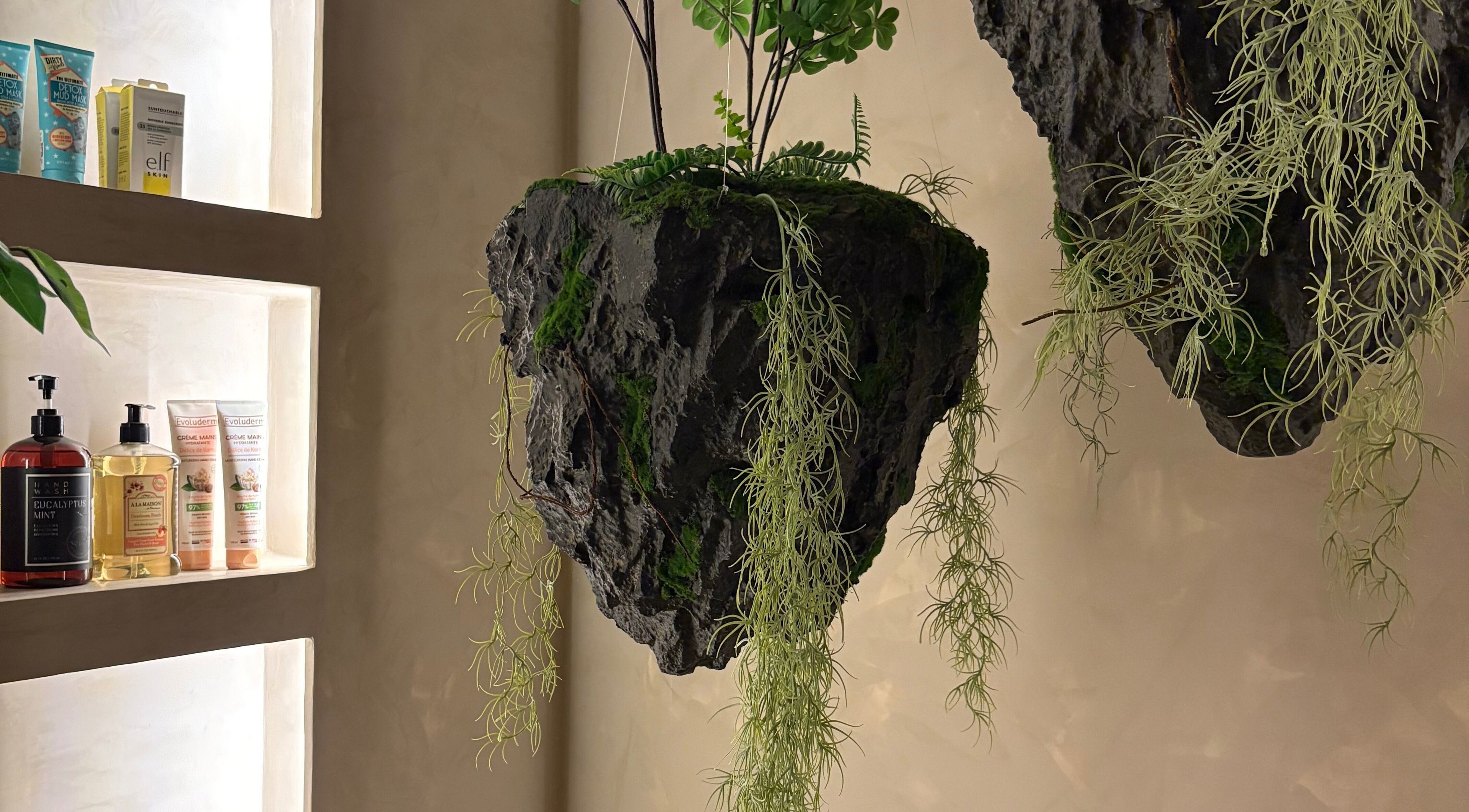 Floating plants and displayed products at Body Retreat Spa, Lagos, Lagos, NG create a serene atmosphere.