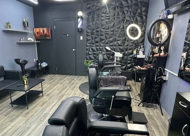Modern interior of Gentlemen Barbershop & Hairstyling, Willemstad, Curaçao, CW showcasing stylish chairs and decor.
