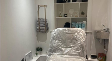 Skn By Leah Jean's tranquil treatment room in Barrhead, Scotland, GB, featuring a plush chair and soothing decor.