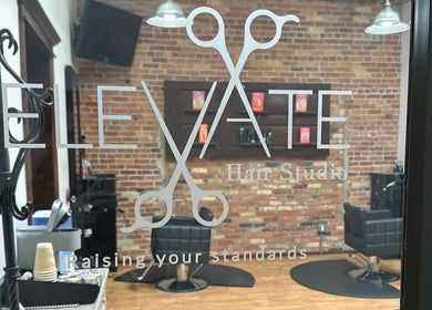 Entrance view of Elevate Hair Studio, showcasing classy interior in De Pere, WI, US.