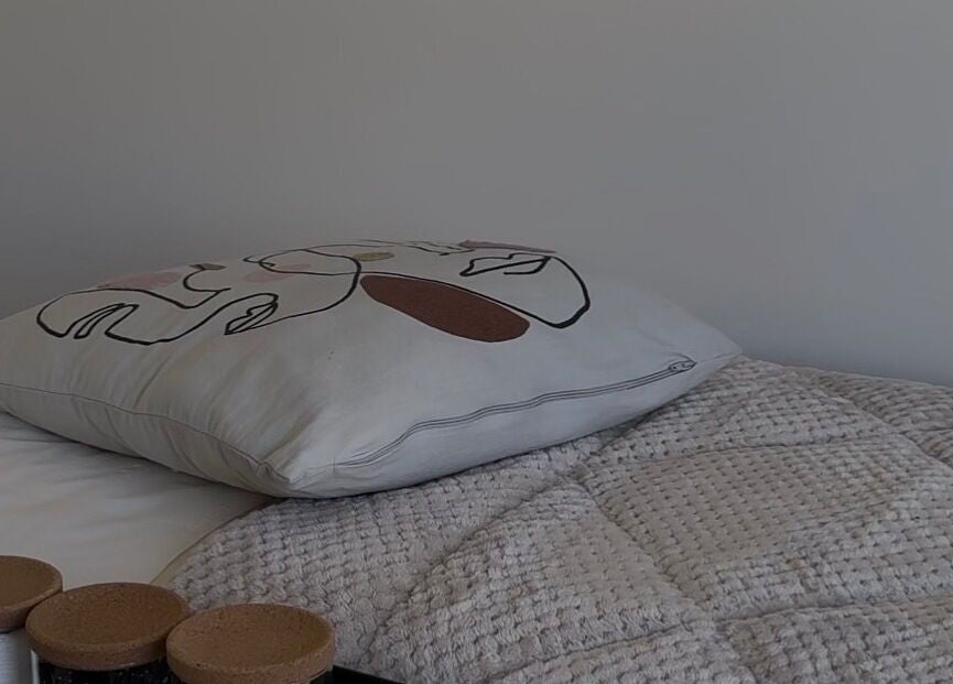 Elegant pillow and textured quilt at The Loft in Colchester, England, GB.