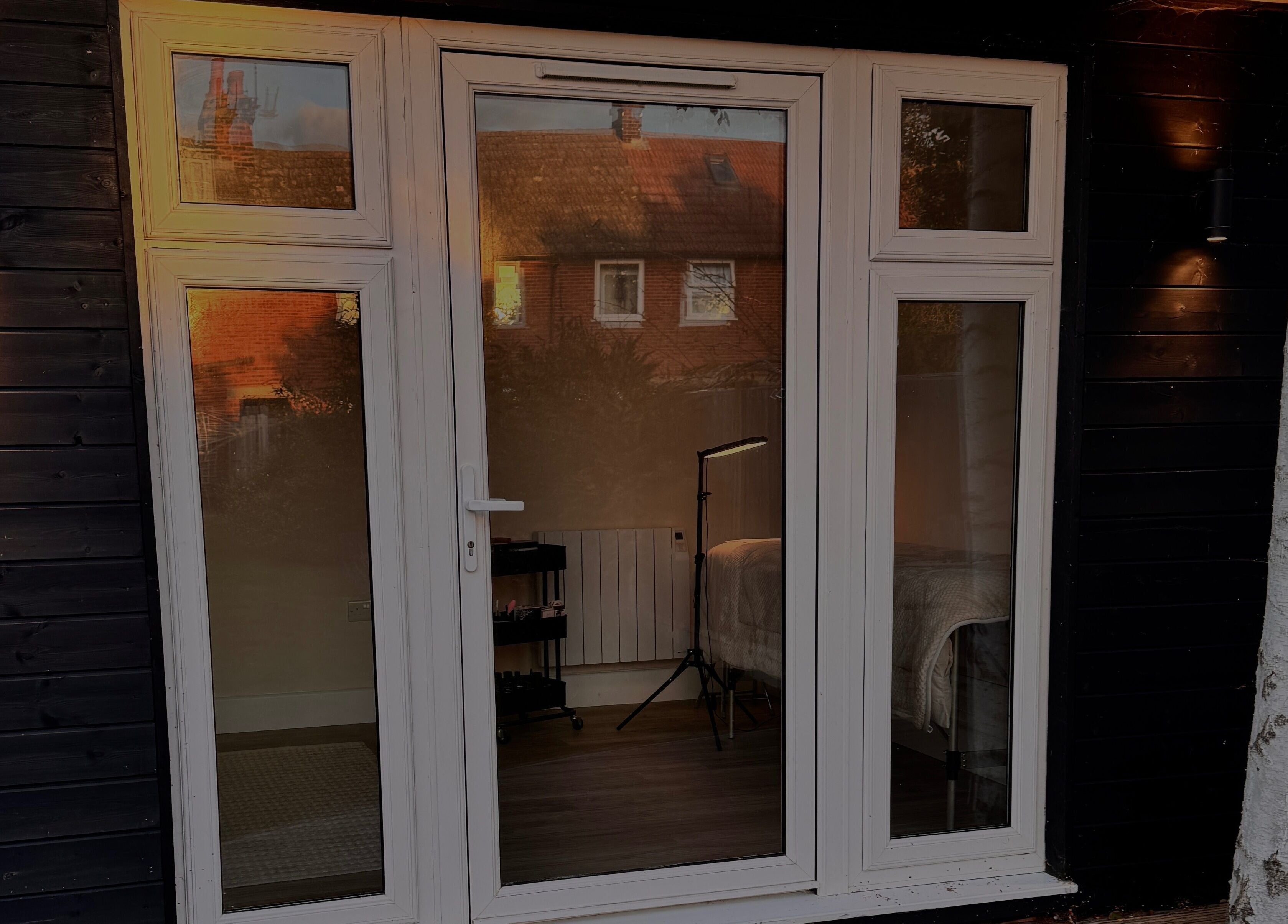 Elegant glass door of The Loft, Colchester, England, GB, with warm interior glow visible through the window.