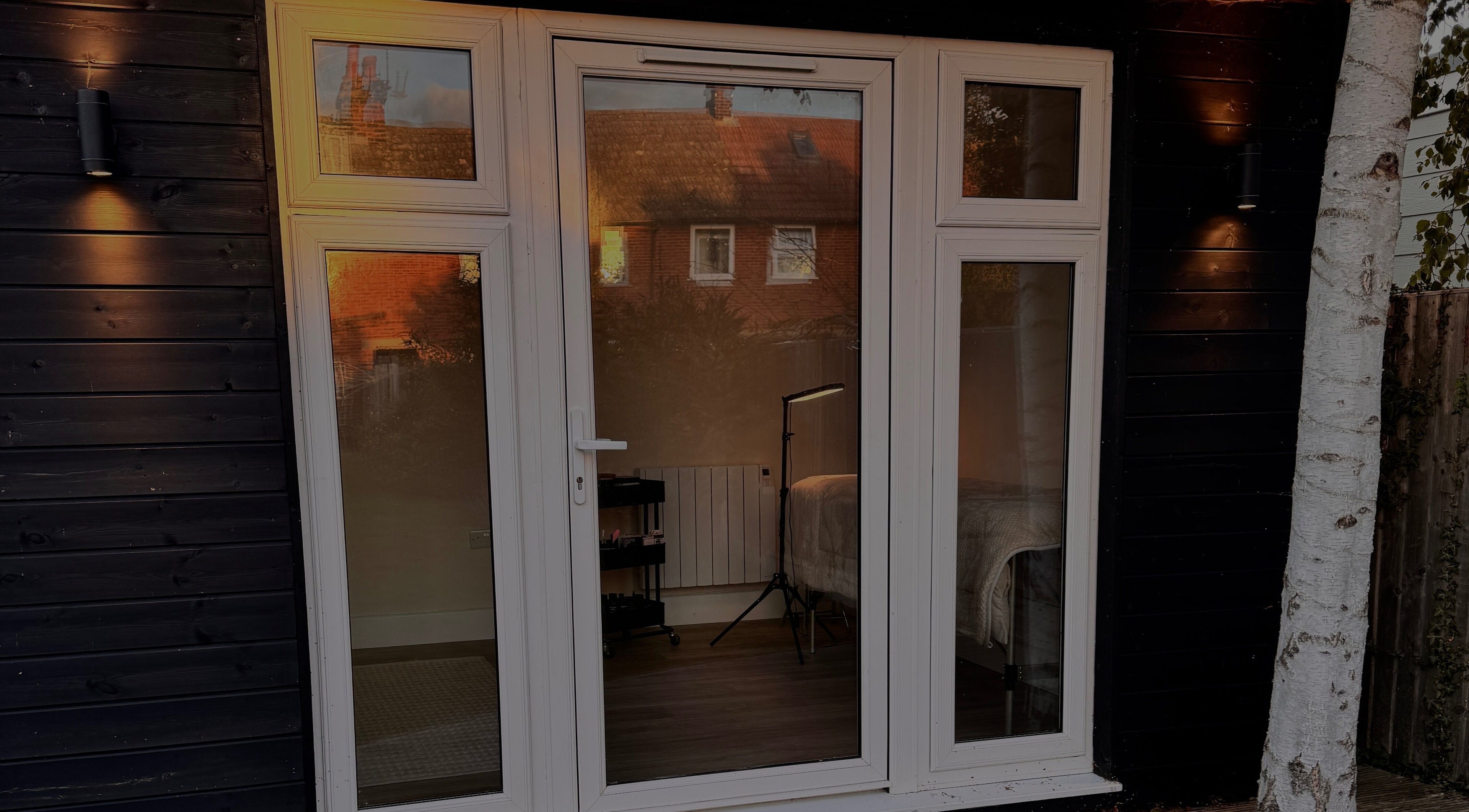 Elegant glass door of The Loft, Colchester, England, GB, with warm interior glow visible through the window.