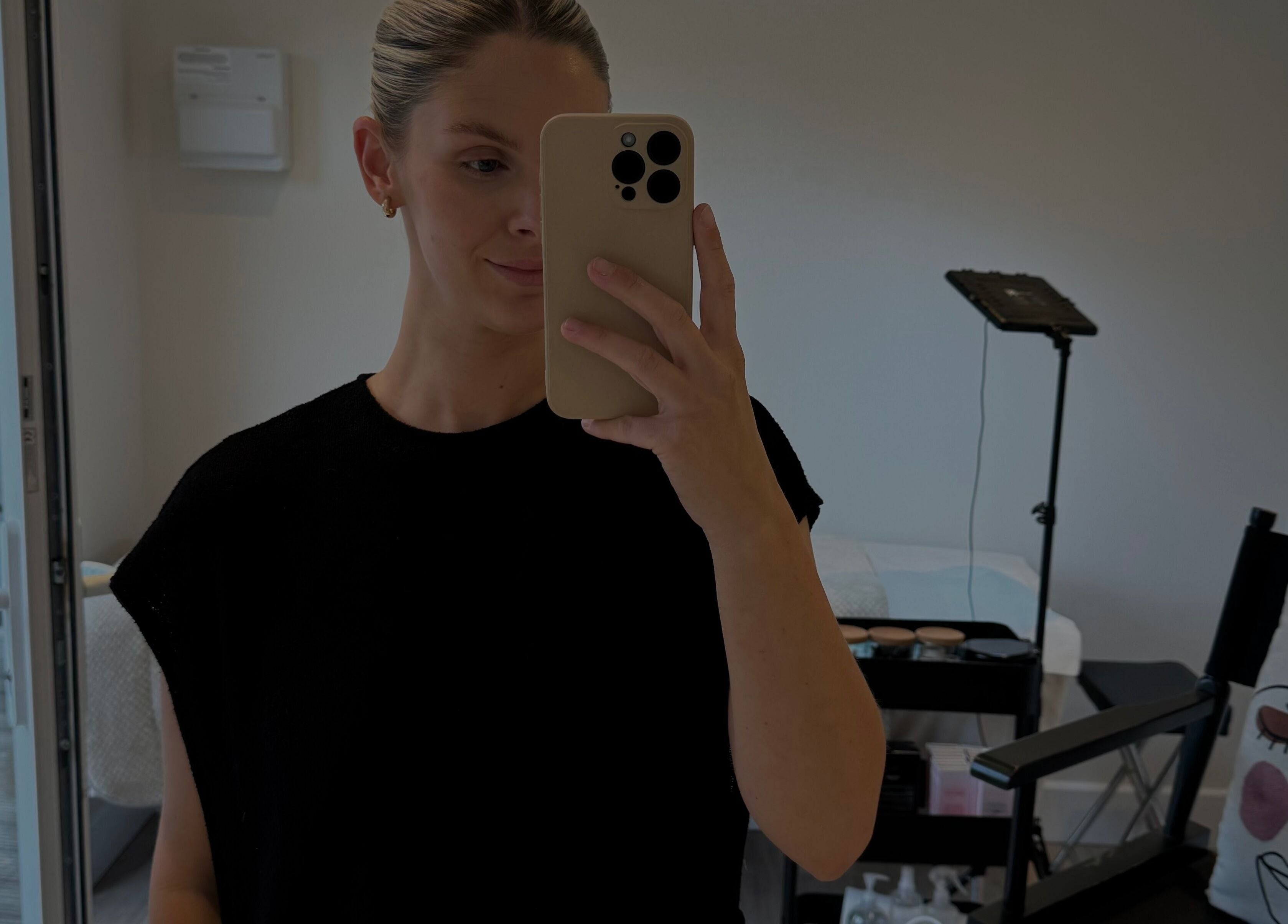 Individual taking a selfie in The Loft beauty studio, Colchester, England, GB. Modern setup visible.