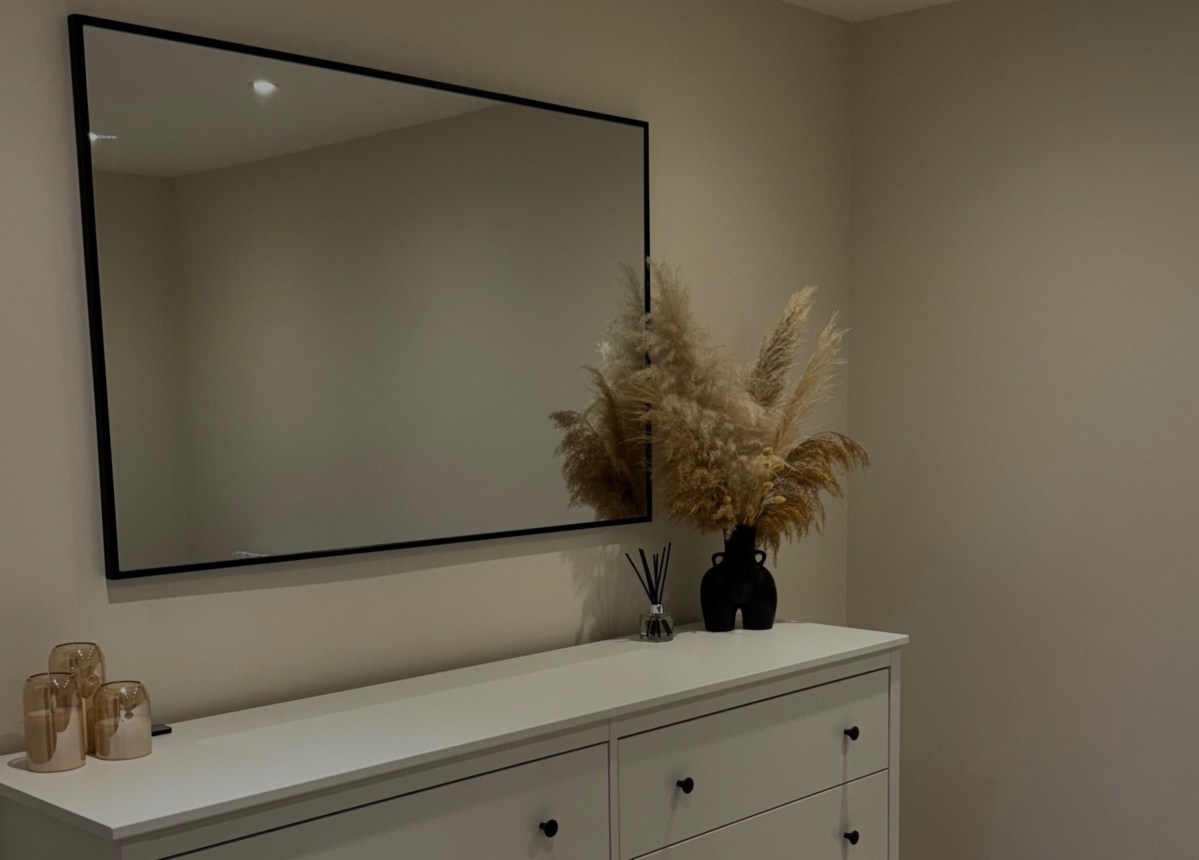 Chic decor at The Loft, Colchester, England, GB, featuring a mirror, dried flowers, and candles.